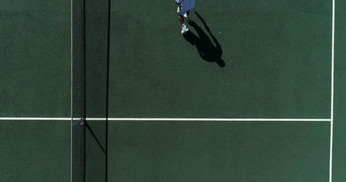A Tenn is player runs back to smash a shot over the net and walks of court at end of game.