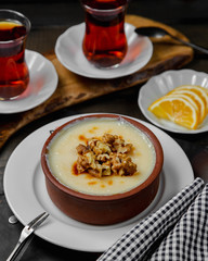 Turkish dessert kazandibi topped with walnuts