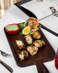 Grilled chicken pieces served with sauce