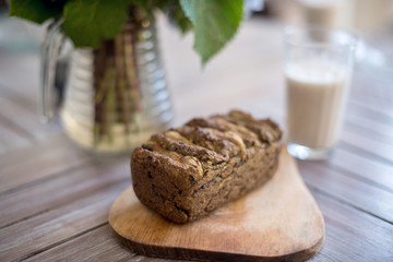 Vegan banana bread with green buckwheat and glass oat milk.