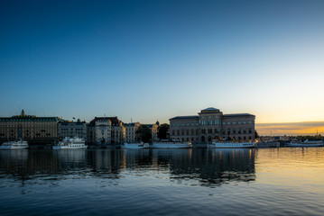 View of the Swedish National Museum building reflecting in the sea water early in the morning in autumn