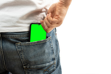 A man pulls a smartphone out of the back pocket of his jeans