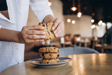 close up photo of delicious and crunchy oatmeal cookies on the backdrop of a cozy restaurant or...