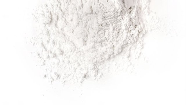 panning Pile of flour isolated on white background .top view