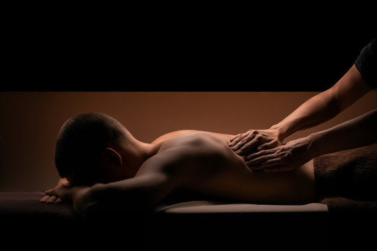 Man getting massage at SPA. Nice warm and beige colors. Copy space