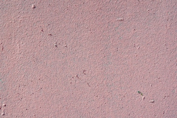 Old pink wall with flecks of dried paint. Pink texture and background