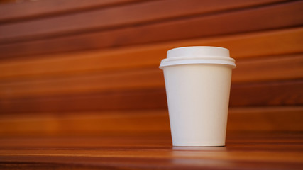 white paper cup on wooden background