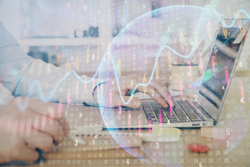 Multi exposure of stock market graph with man working on laptop on background. Concept of financial analysis.