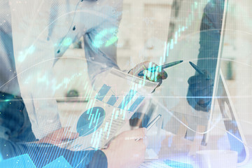 Multi exposure of chart with man typing on computer in office on background. Concept of hard work.