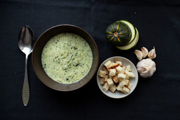 green healthy creamy soup with croutons.top view