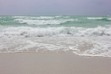 Waves of ocean on beach during daytime