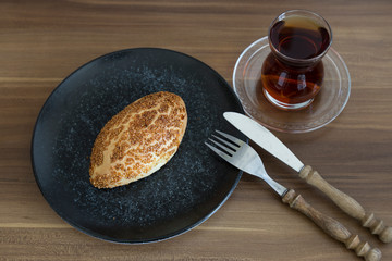 Turkish pastry products are Pogaca, Simit at patisserie on the wooden background.