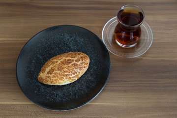 Turkish pastry products are Pogaca, Simit at patisserie on the wooden background.
