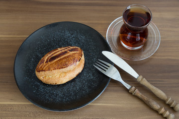 Turkish pastry products are Pogaca, Simit at patisserie on the wooden background.