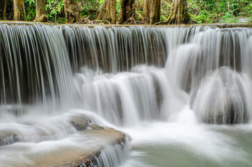 Fototapeta na wymiar Travel to the beautiful waterfall in tropical rain forest, soft water of the stream in the natural park at Huai Mae Khamin Waterfall in Kanchanaburi, Thailand.