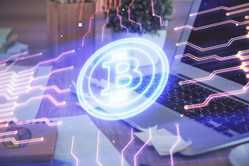 Multi exposure of blockchain theme hologram and table with computer background. Concept of bitcoin crypto currency.