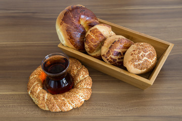 Turkish pastry products are Pogaca, Simit at patisserie on the wooden background.