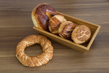 Turkish pastry products are Pogaca, Simit at patisserie on the wooden background.