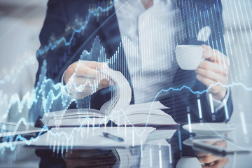 Double exposure of businessman with coffee with stock market forex chart.