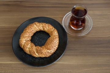 Turkish pastry products are Pogaca, Simit at patisserie on the wooden background.