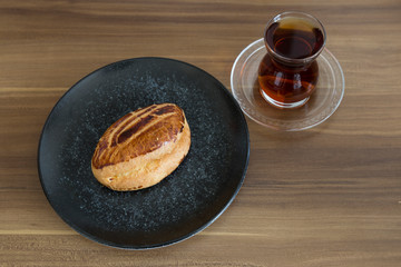 Turkish pastry products are Pogaca, Simit at patisserie on the wooden background.