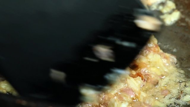 Frying chopped garlic in pan, Chiangmai Thailand.