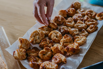 hands with fresh sweets or donuts, pastries and sweets