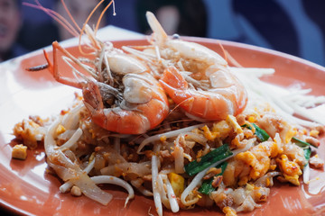 Pad Thai with fresh prawns in an orange plate