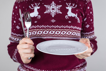 Waiting for tasty homemade food nutrition concept. Cropped close up photo of happy lady using holding fork knife and white plate with hands asking for delicious nutrition isolated grey background