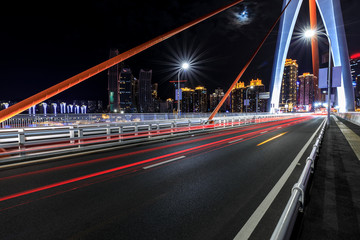 Fototapeta na wymiar Urban road and bridge buildings pass through the financial district in Chongqing at night,China.