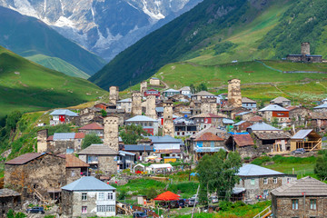 View of the Ushguli village at the foot of Mt. Shkhara. Picturesque and gorgeous scene. Rock towers and old houses in Ushguli, Georgia.