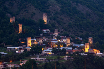 Night view on Mestia with its beautiful illuminated Svan Towers and high mountains. Svaneti, Georgia.