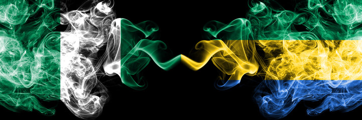 Nigeria vs Gabon, Gabonese abstract smoky mystic flags placed side by side. Thick colored silky...