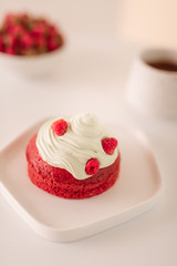 Obraz na płótnie Canvas Raspberry muffins with cream on white background