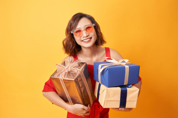 Portrait of casual young happy smiling woman hold gift box.