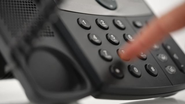 Male hand dialing telephone number
