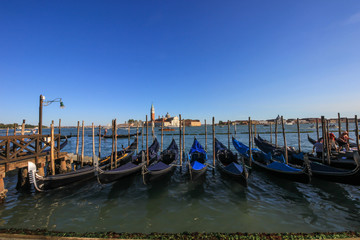 Gondolas on a pier at Grand Canal, Venice, Italy.