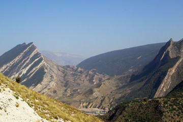 mountain lake in the valley in the distance against the backdrop of peaks, Russian, Dagestan