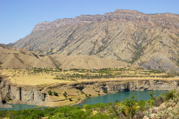 Naklejka premium mountain lake in the valley in the distance against the backdrop of peaks, Russian, Dagestan
