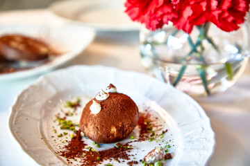 Traditional dessert of the USSR and Russia-kartoshka is on a plate in the restaurant