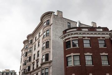 Layers of brick faced urban housing buildings with ornate architectural details, horizontal aspect