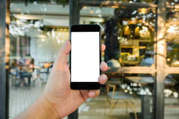 big hand holding blank screen phone on window cafe shop.blurred background
