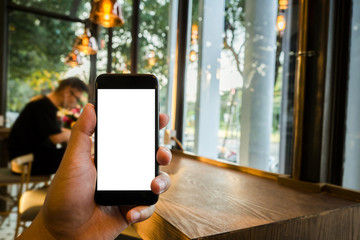 hand holding blank screen phone on cafe shop.sensitive background