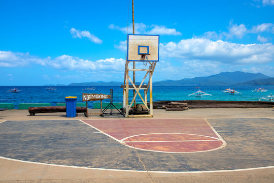 Basketball backboard on seaside landscape. Basketball playground on seashore. Outdoor sport in the Philippines.