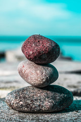 zen stones on the beach with sea view
