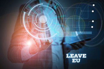 Word writing text Leave Eu. Business photo showcasing An act of a demonstrating to leave a country that belongs to Europe Woman wear formal work suit presenting presentation using smart device