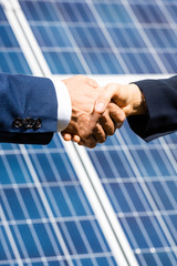 cropped view of businessman and businesswoman shaking hands outside