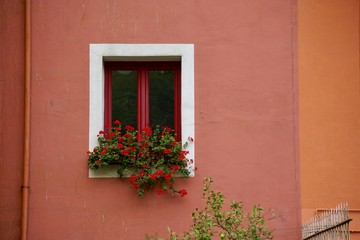 window on the red facade of the building in Bilbao city Spain