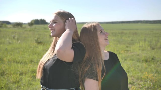 Portrait of two fair-haired twin sisters.
