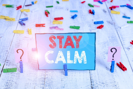 Word writing text Stay Calm. Business photo showcasing Maintain in a state of motion smoothly even under pressure Scribbled and crumbling sheet with paper clips placed on the wooden table